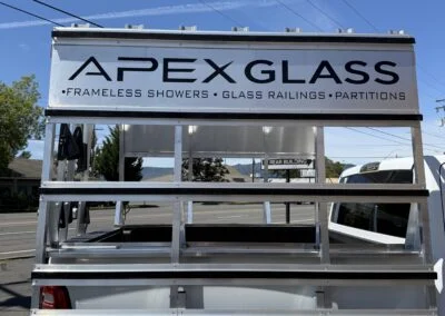 Apex Glass sign atop an aluminum glass rack on a truck