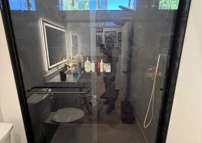 Black-framed glass shower enclosure in a modern bathroom
