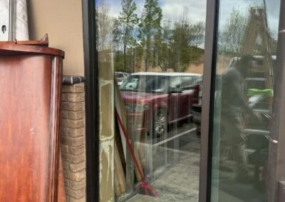 Black-framed glass storefront door and windows