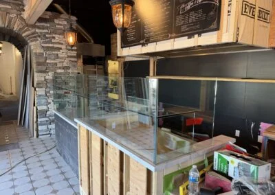 Clear glass guard panels on a restaurant counter during build-out