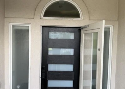 Front entry with frosted glass sidelights and arched transom