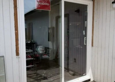New white sliding glass patio door in a home exterior